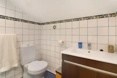 a bathroom with a toilet and a sink at Casa Amarela in Caniço