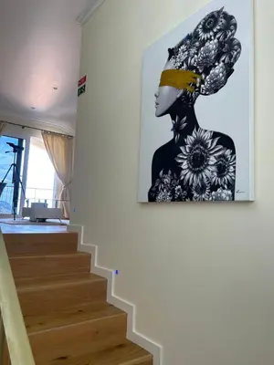 a painting of a woman on a wall next to a staircase at Casa Del Mar in Ponta do Sol