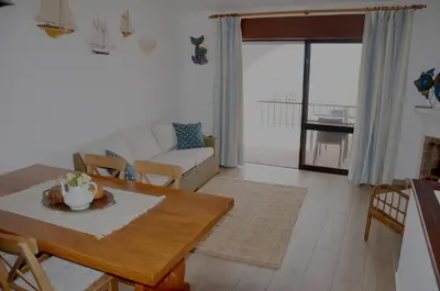 a living room with a table and a couch at Casa Vista Mar in Luz