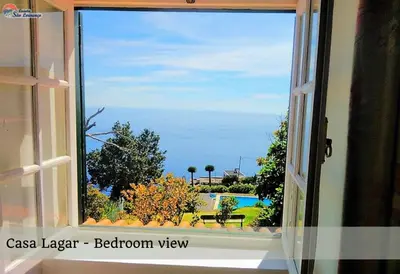 an open window with a view of a pool at Quinta São Lourenço in Fajã da Ovelha