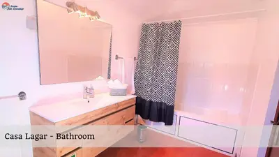 a bathroom with a sink and a mirror at Quinta São Lourenço in Fajã da Ovelha