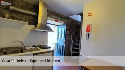 a kitchen with a sink and a blue door at Quinta São Lourenço in Fajã da Ovelha