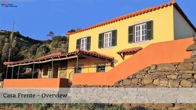 a yellow house with a staircase in front of it at Quinta São Lourenço in Fajã da Ovelha