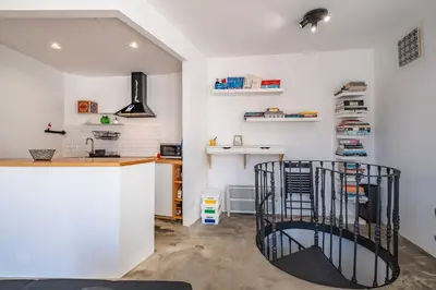 a room with white walls and a counter with a desk at Casa do Luar - By WeHost in Funchal