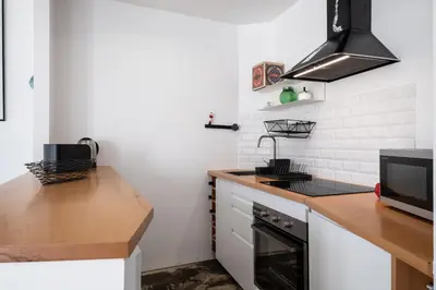 a kitchen with white walls and a stove top oven at Casa do Luar - By WeHost in Funchal
