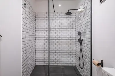a shower with a glass door in a bathroom at Casa do Luar - By WeHost in Funchal