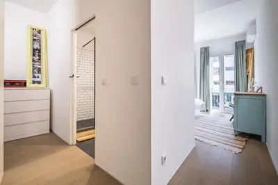a white room with a mirror and a hallway at Casa do Luar - By WeHost in Funchal