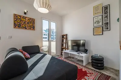 a bedroom with a bed and a tv and a couch at Casa do Luar - By WeHost in Funchal