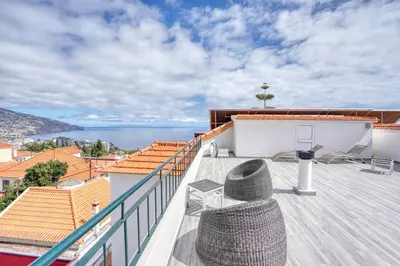 a view of the ocean from the balcony of a house at Vila Camacho Guest House in Funchal