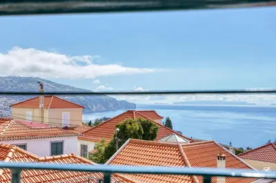 a view of a town with orange tile roofs at Vila Camacho Guest House in Funchal