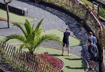 a group of people standing on a tennis court at Village Cabo Girao in Câmara de Lobos