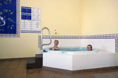 a man and a woman in a bath tub at Village Cabo Girao in Câmara de Lobos