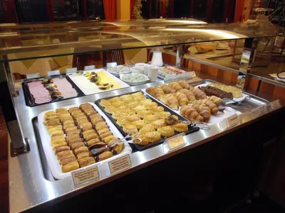 a display case with many different types of donuts at Village Cabo Girao in Câmara de Lobos