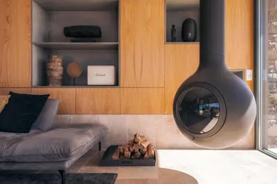 a living room with a fireplace and a couch at The Rock Villas in Estreito da Calheta