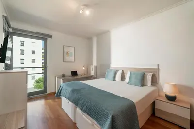 a bedroom with a large bed and a window at Piornais Residence I by An Island Apart in Funchal