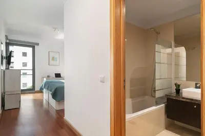 a bathroom with a bed and a tub and a sink at Piornais Residence I by An Island Apart in Funchal