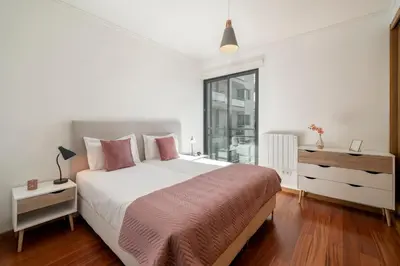 a white bedroom with a large bed and a window at Piornais Residence I by An Island Apart in Funchal