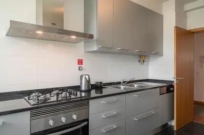 a kitchen with a sink and a stove at Piornais Residence I by An Island Apart in Funchal