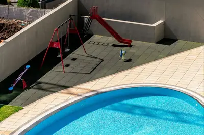 a swimming pool with a red slide next to a house at Piornais Residence I by An Island Apart in Funchal