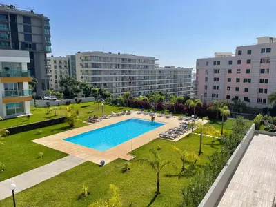 an overhead view of a swimming pool in a park with buildings at Pool view apartment in Funchal