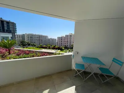 a balcony with two chairs and a view of the city at Pool view apartment in Funchal