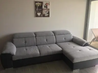 a gray couch in a living room at Pool view apartment in Funchal