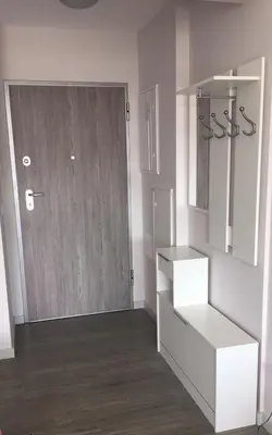 a room with a white door and a wooden floor at Pool view apartment in Funchal