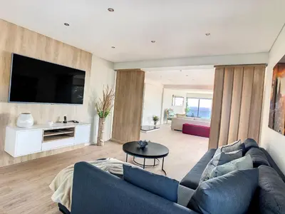 a living room with a couch and a tv at Villa Bahari by LovelyStay in Caniçal