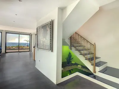 a staircase in a house with a green wall at Villa Bahari by LovelyStay in Caniçal