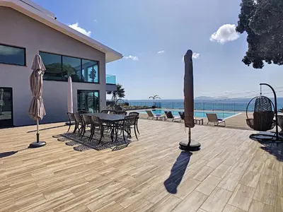a house with a patio with a table and chairs at Villa Bahari by LovelyStay in Caniçal