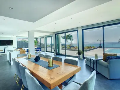 a living room with a wooden table and chairs at Villa Bahari by LovelyStay in Caniçal