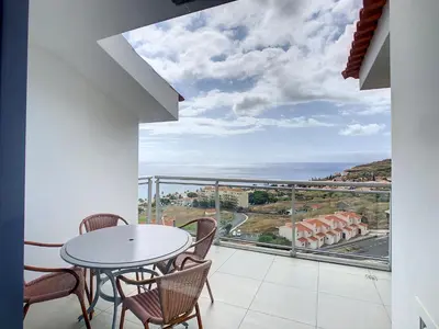 a balcony with a table and chairs and a view of the ocean at Heaven I by LovelyStay in Caniço