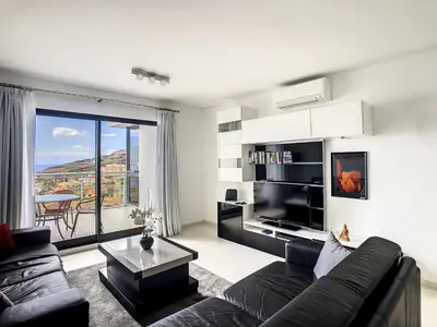 a living room with a couch and a table at Heaven I by LovelyStay in Caniço