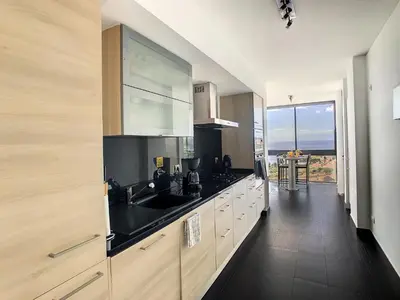 a kitchen with a sink and a view of the ocean at Heaven I by LovelyStay in Caniço