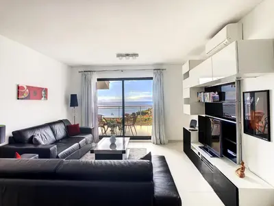 a living room with a couch and a large window at Heaven I by LovelyStay in Caniço