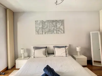 a bedroom with a large white bed with two lamps at Samya Apartment by LovelyStay in Funchal