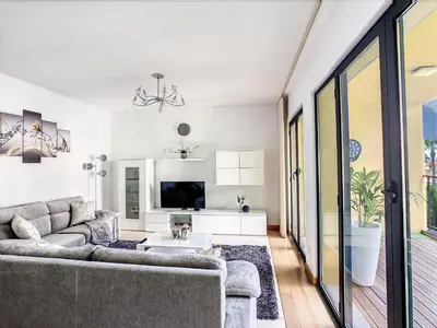 a living room with a couch and a tv at Samya Apartment by LovelyStay in Funchal