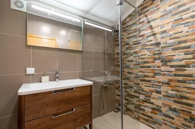 a bathroom with a sink and a glass shower at Casa Raimunda, Big apartment with amazing views in Arco da Calheta