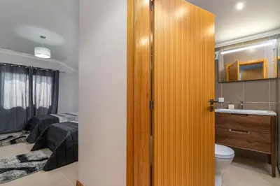 a bathroom with a yellow door leading to a bedroom at Casa Raimunda, Big apartment with amazing views in Arco da Calheta