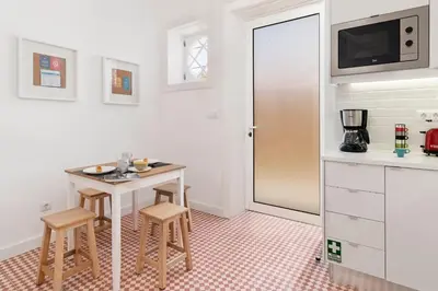 a kitchen with a small table and two stools at The Yellow House by LovelyStay in Funchal