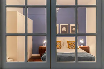 a view of a bedroom through a window at The Yellow House by LovelyStay in Funchal
