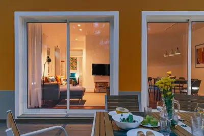 a dining room with a table and a living room at The Yellow House by LovelyStay in Funchal