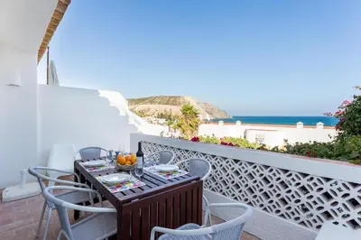 a bottle of wine and a glass on a table at CoolHouses Algarve Luz, 3 Bed Townhouse w/ beautiful sea view, Luz Bay 76 in Luz