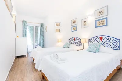 a white bedroom with a bed and a table at CoolHouses Algarve Luz, 3 Bed Townhouse w/ beautiful sea view, Luz Bay 76 in Luz