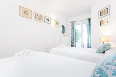 two beds in a room with white walls at CoolHouses Algarve Luz, 3 Bed Townhouse w/ beautiful sea view, Luz Bay 76 in Luz