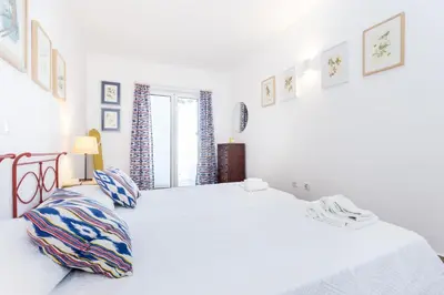 two beds in a room with white sheets at CoolHouses Algarve Luz, 3 Bed Townhouse w/ beautiful sea view, Luz Bay 76 in Luz