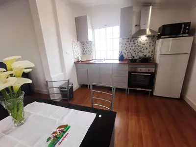 a kitchen with a table and a counter top at Casa do Curral Velho in Santana