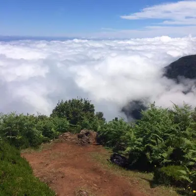 a view of clouds from the top of a mountain at Casa do Curral Velho in Santana