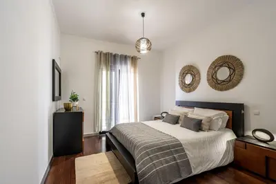 a bedroom with a bed and a mirror on the wall at City View Apartment by Homie in Funchal