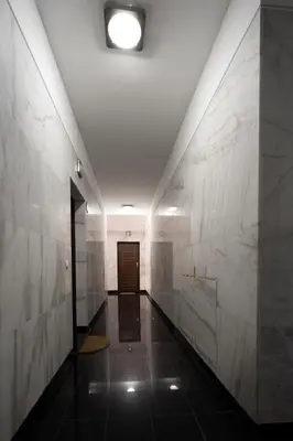 a hallway with white marble walls and a door at City View Apartment by Homie in Funchal